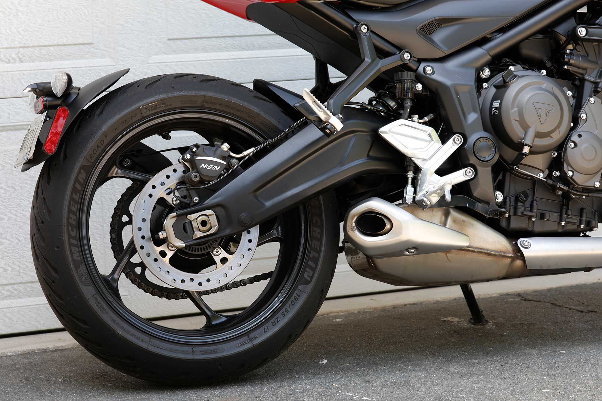 We’re big fans of the Trident’s oversized rear brake disc. A shapely swingarm hides the shock linkage.