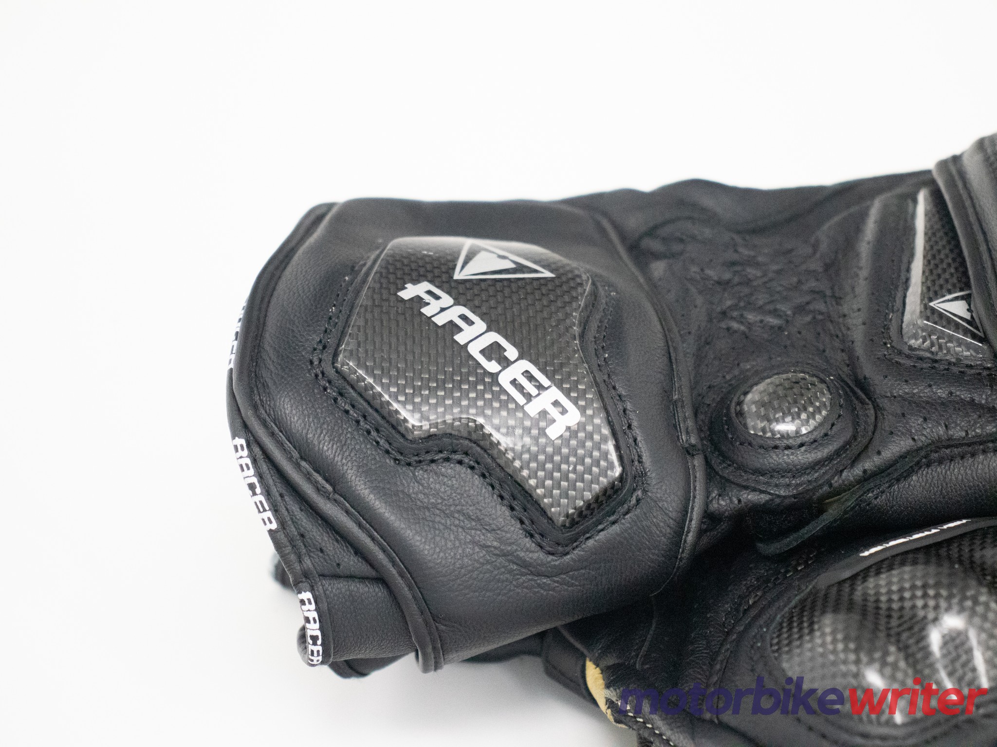 Closeup of carbon fiber and Racer logo on glove cuff