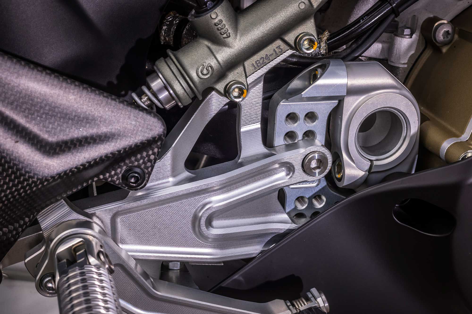 Billet aluminum footpegs with carbon heel plates and articulated brake and shift pedals to minimize the risk of breaking in the event of a slide. The gear selector can be quickly reversed to a race shift pattern.