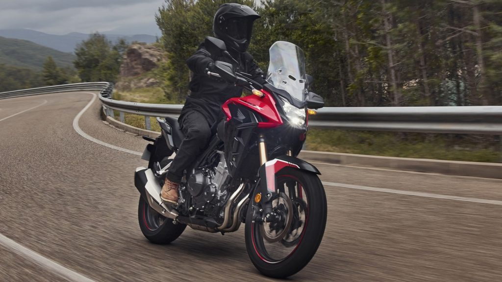 A view of a rider enjoying the new 2022 Honda CB500X in Grand Prix Red
