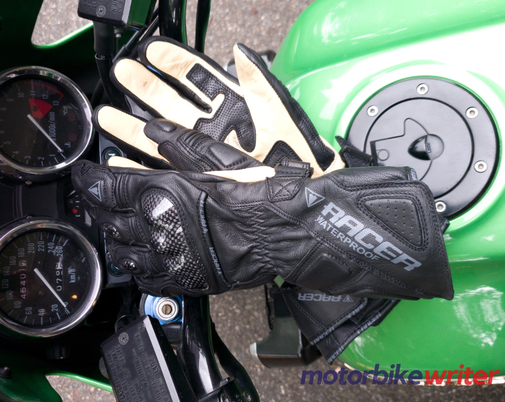 Racer Multitop 2 Waterproof Gloves sitting on green motorcycle fuel tank