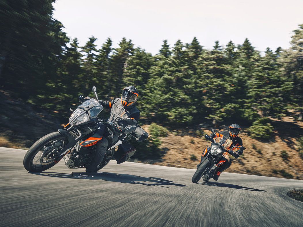 A shot of two KTM 390 Adventures' riding on tarmac