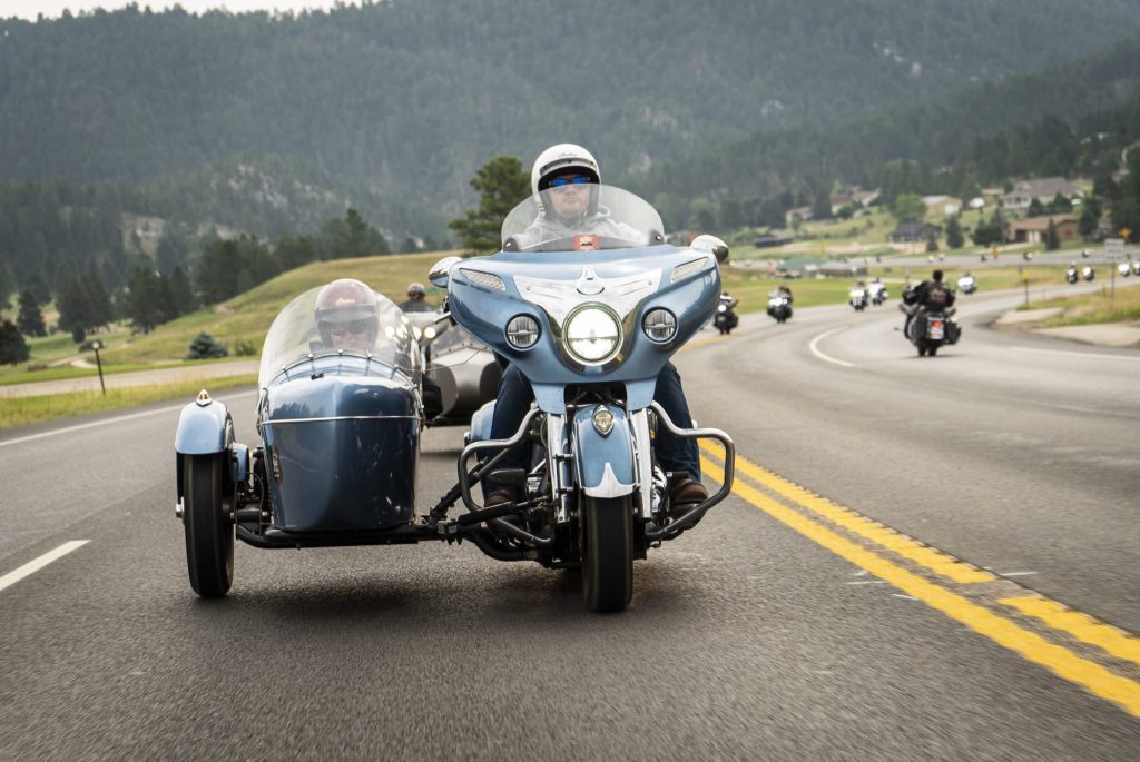 A motorcycle rider with a sidecar in the rehabilitation efforts for American vets. Photo courtesy of Coffee or Die Magazine.