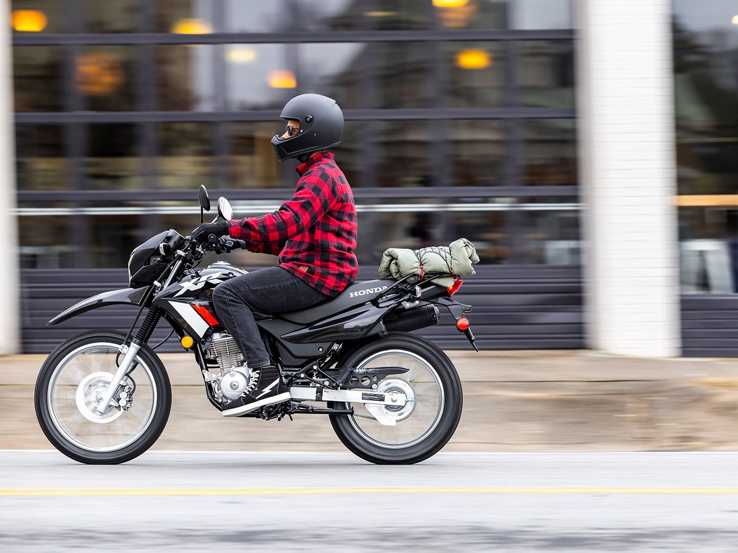 Stowing some equipment on the XR150L’s standard luggage rack could be useful for city rides and weekend adventures alike.