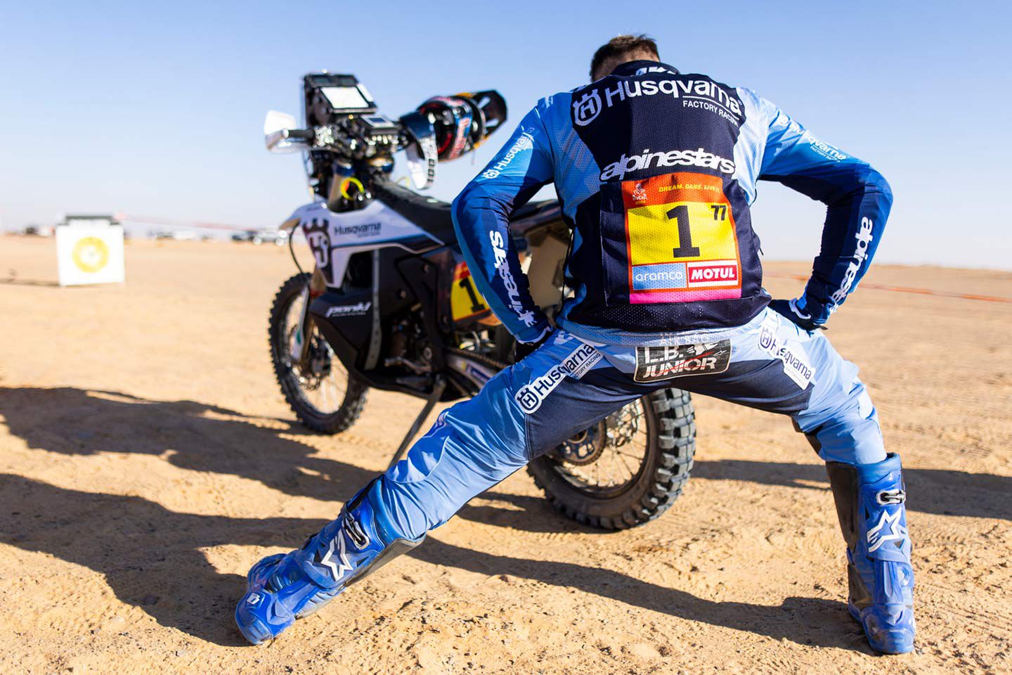 Luciano Benavides stretches before manning his Husqvarna Factory Racing Husqvarna during Stage 4. He would finish fourth overall.
